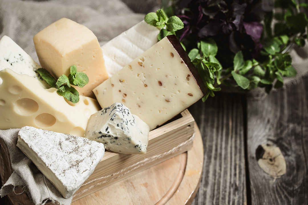 arrangement-of-gourmet-cheese-on-wooden-background-concept-of-gourmet-cheeses