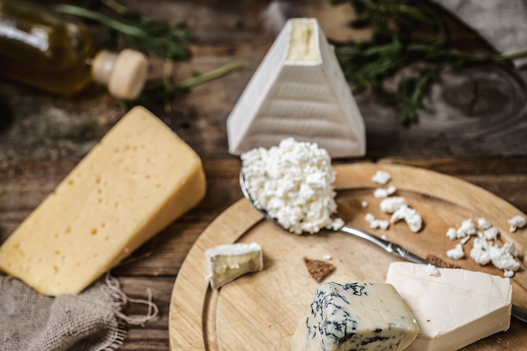 different-types-of-cheese-on-wooden-background-composition-delicatessen-concept-and-gourmet-cheeses